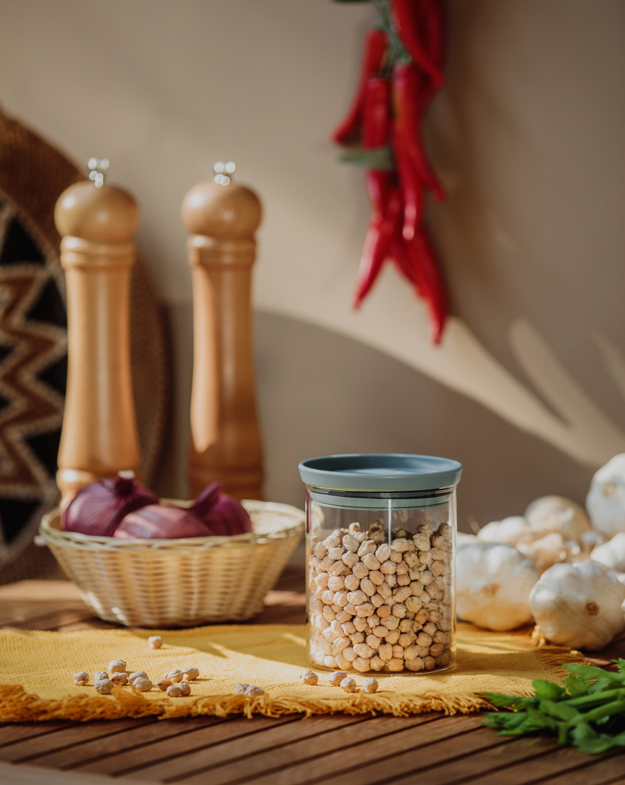 side view of a glass jar with dry peas on a wooden table